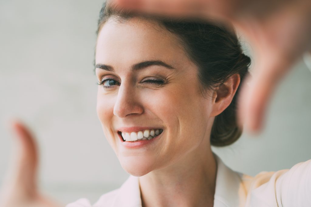 Woman framing her face with hands