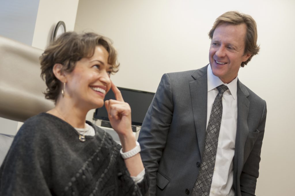 Dr. Kenkel visits with a patient in his Dallas Clinic